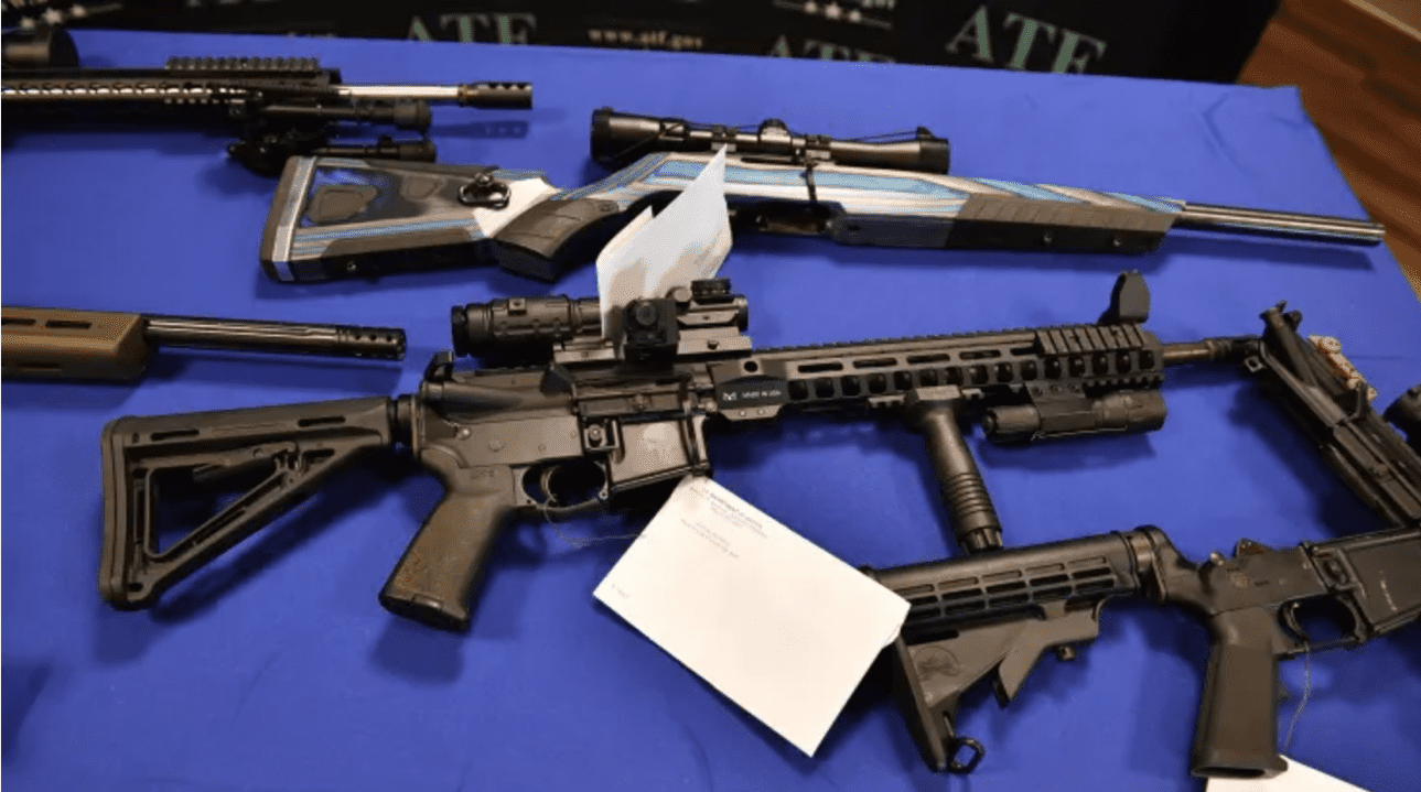 Several guns laid out on a table